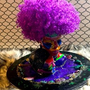 Ceramic art of a woman and child painted and sealed with resin.